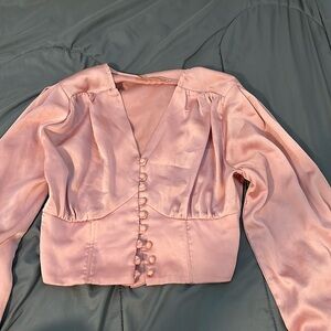 pink satin blouse, V-neck, long sleeves, cropped. Perfect for any occasion.
